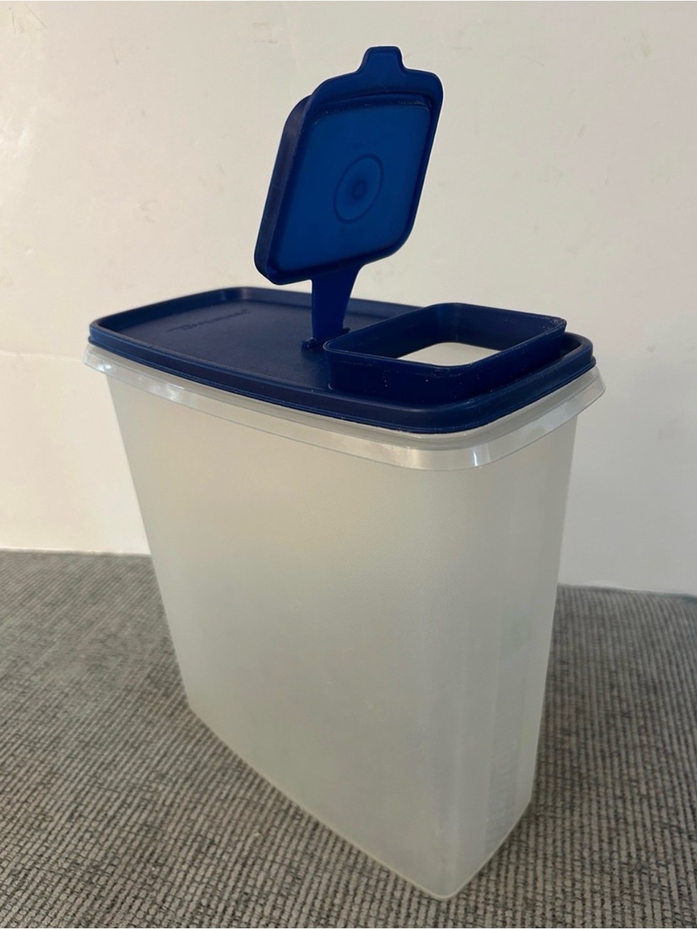 ❌final: firm❌ Tupperware Cereal Keeper featuring a sheer base and blue flip-top